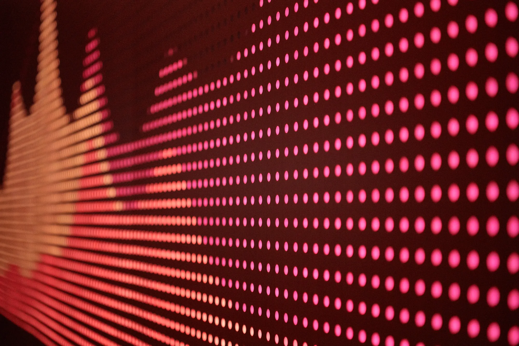 A wall of red and pink points of light forming a data graph.