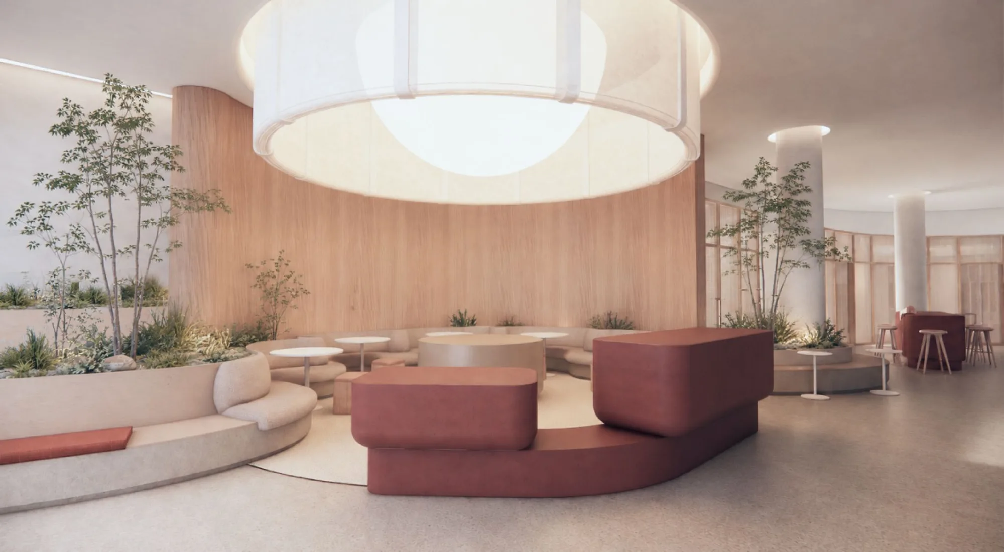 Rendered interior with a circular sunken lounge, oxblood sofas, small trees, and a large diffused ceiling light.