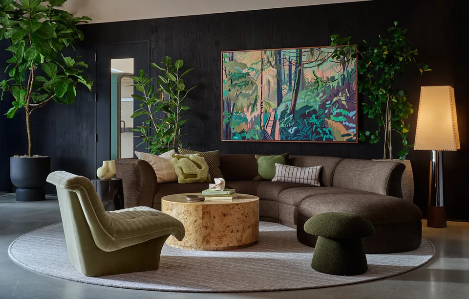 Sofa group with a large landscape painting on a black timber wall at Bellevue.