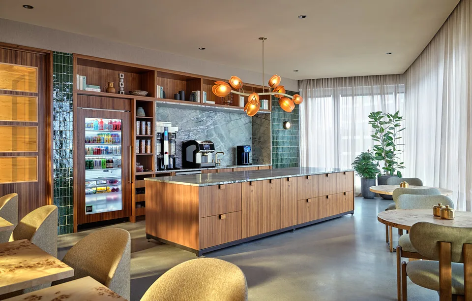 The Bellevue cafe counter, with a green tile wall and brass pendants.