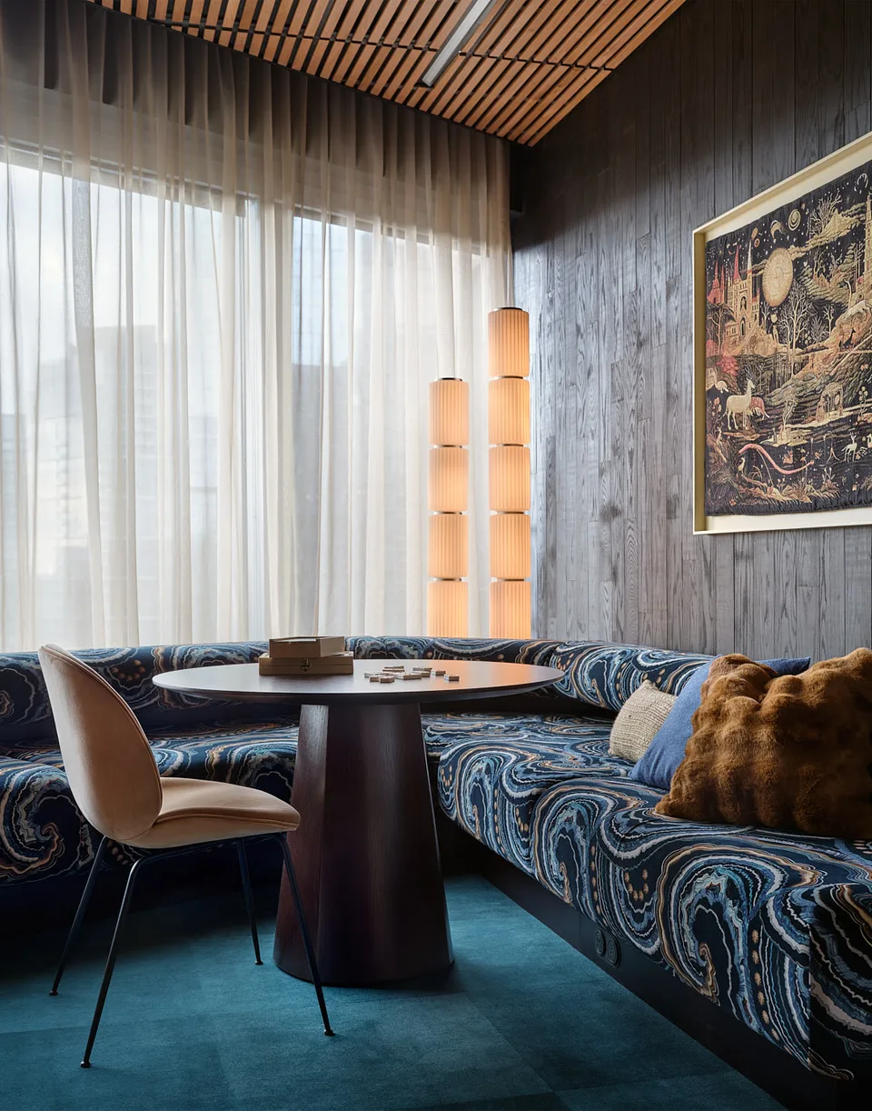A banquette in blue patterned upholstery around a small round table at Bellevue.