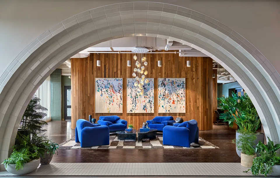 Blue lounge chairs in the Bellevue reception, framed by a pale arch.