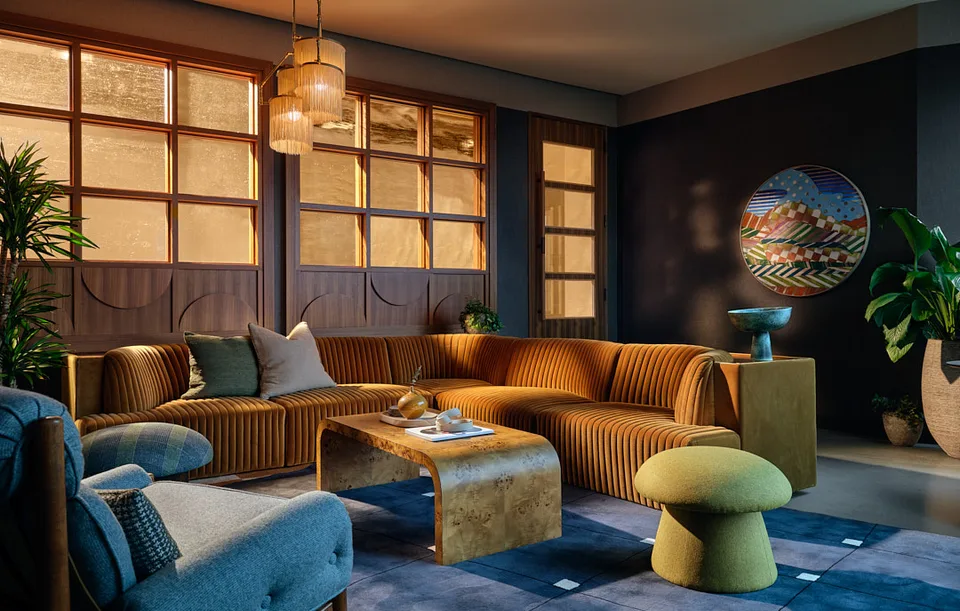 A velvet sectional in the Bellevue team room beside leaded glass windows.